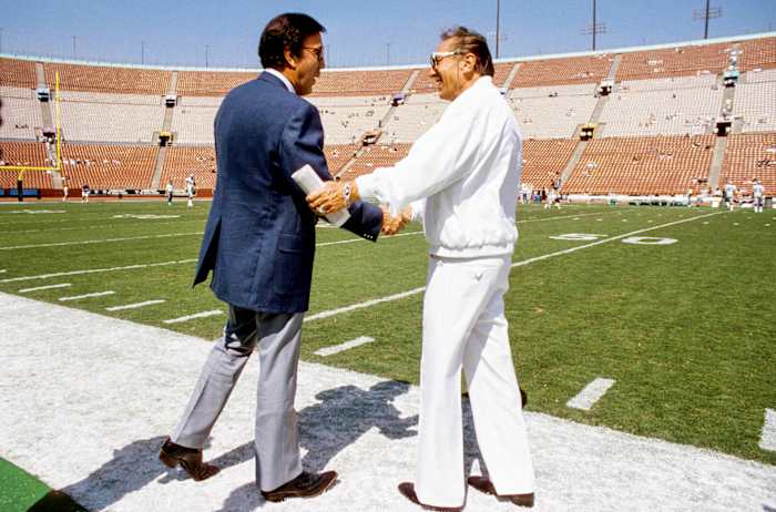 Tom Flores, then with the Seattle Seahawks, greets Raiders owner Al Davis before a game